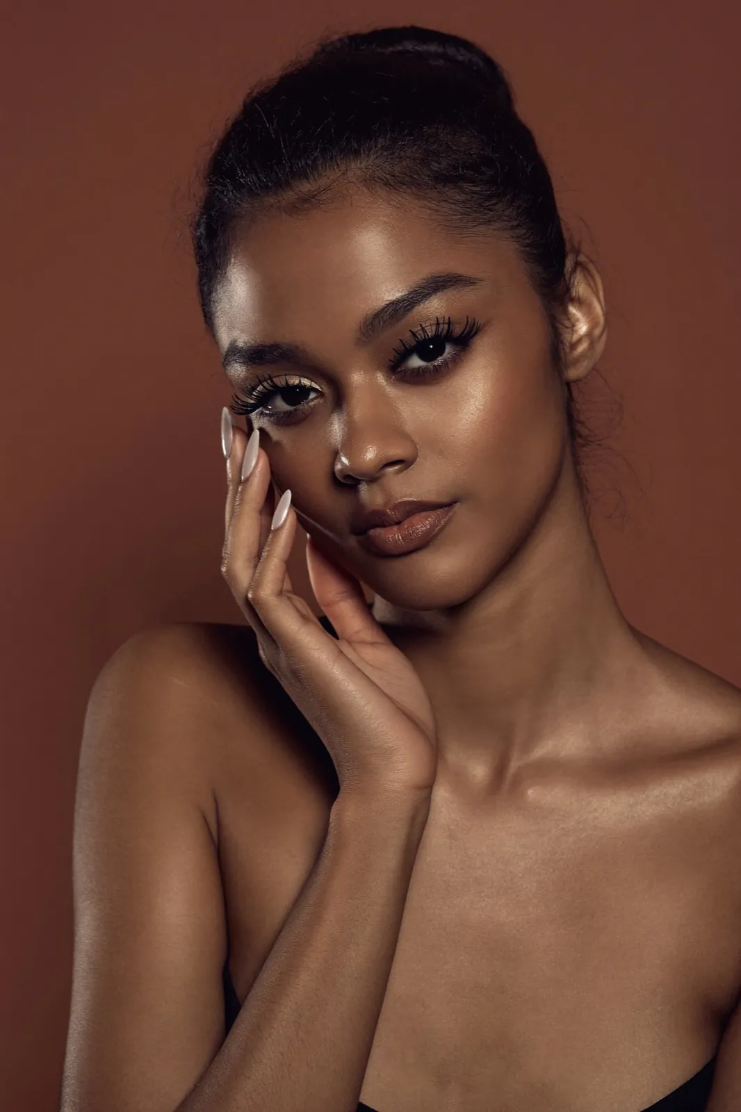 Beauty portrait with defined lashes and manicured nails